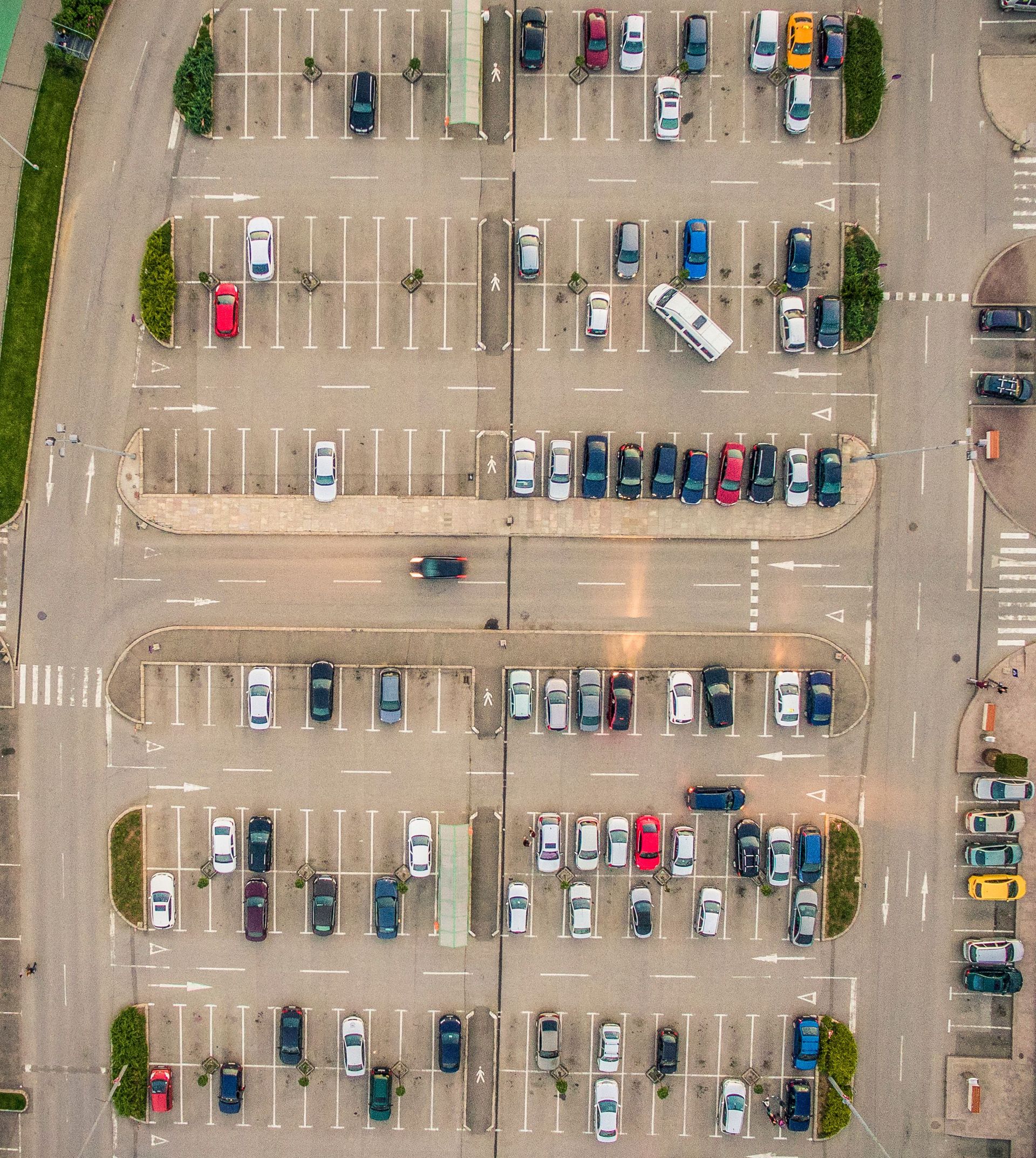 Drone shot of a parking lot with multiple parked cars in Timișoara, Romania.