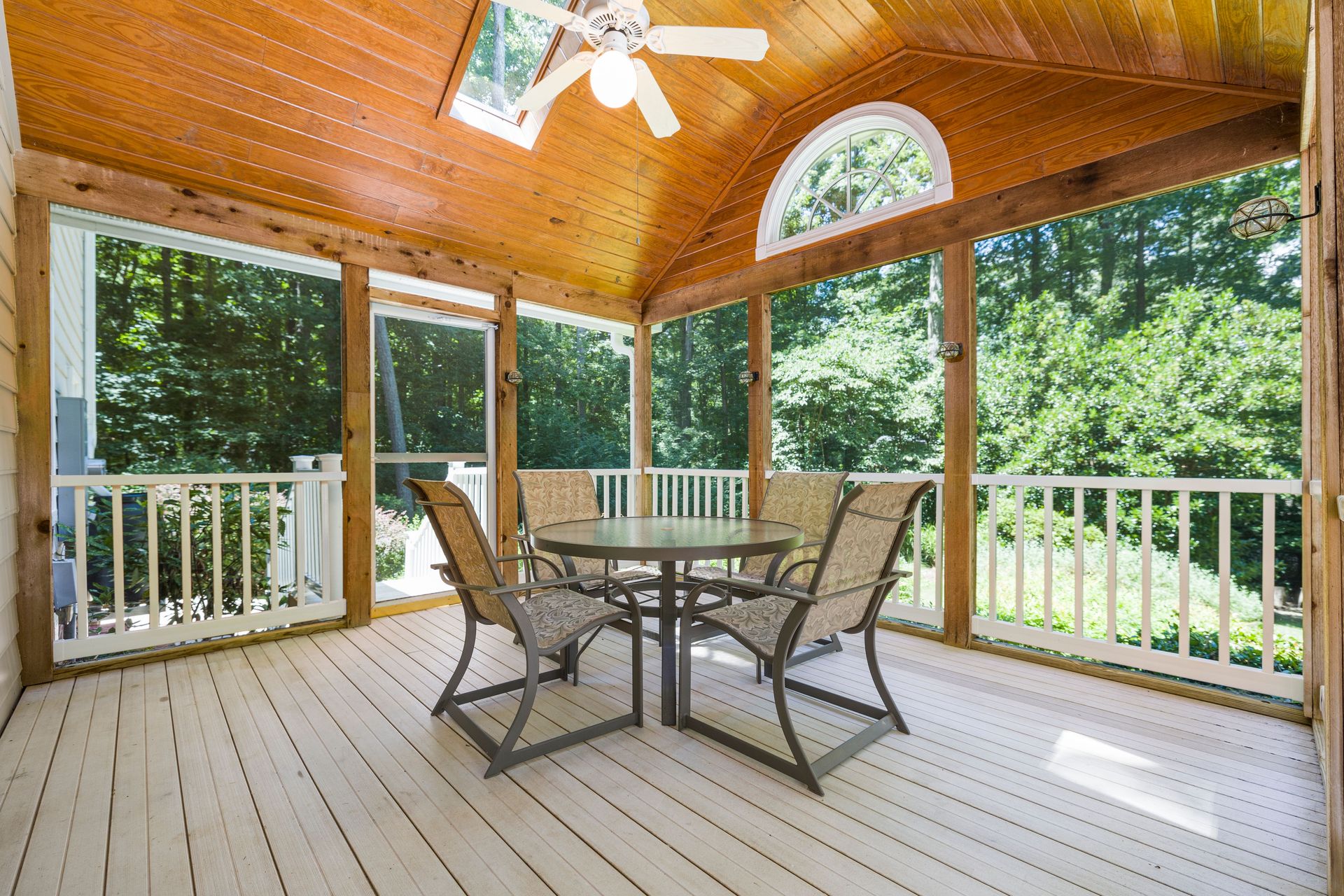 Inviting porch with wooden ceiling and garden views, ideal for relaxation.